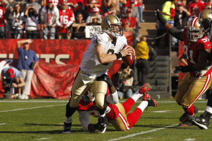 Jan 14, 2012; New Orleans Saints quarterback Drew Brees (9) escapes San Francisco 49ers linebacker Aldon Smith (bottom) during the first quarter of the 2011 NFC divisional playoff game. Mandatory Credit: Cary Edmondson-USA TODAY Sports